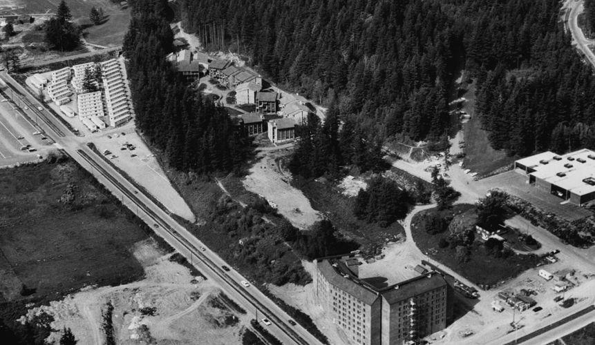 aerial view of campus, 1971, shows large buildings and parking lots between streets
