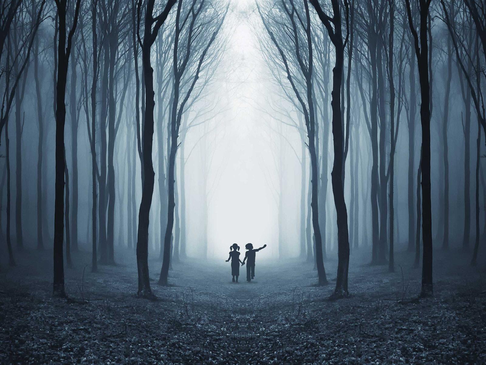 two tiny figures hold hands in an eerie forest