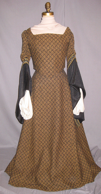brown dress with diamond pattern, flared dark sleeves.