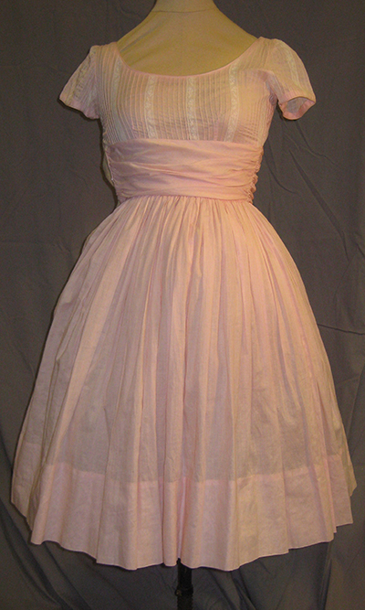 pink semi-formal dress. Wide ribbon belt, scoop neck, short sleeve, mid calf length.