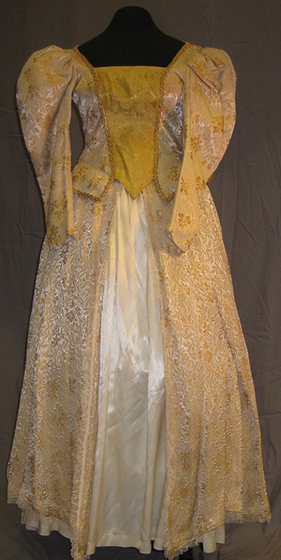 Ornate cream colored gown. Satin panels, gold detail. Embroidered.