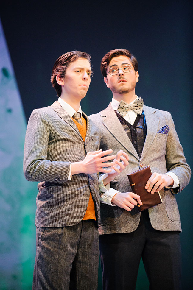 two studious fellows in ascots and waistcoats consider something wieighty in song