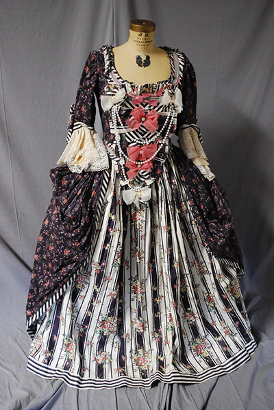 elaborate patterned dress with patterened surcoat, bows, low neckline