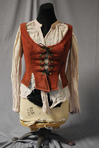 peasant blouse and laced bodice, looking well worn.