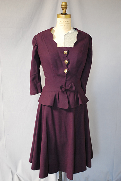 1940s burgundy dress. A-line skirt. Three buttons up front of bodice, flare at waist.