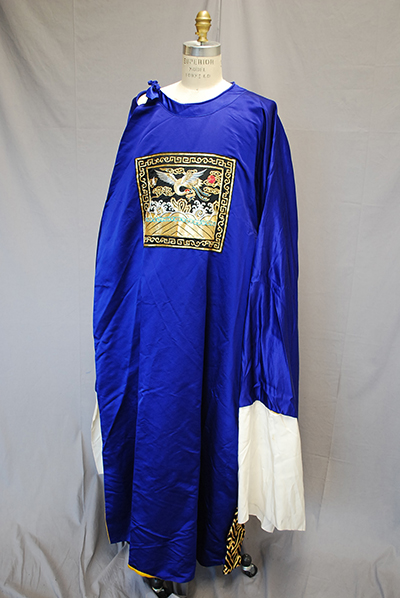 bright blue dress with hem-length sleeves. Picture embroidered on breast.