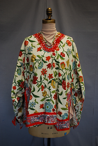 lavishly embroidered blouse with red trim and floral motif