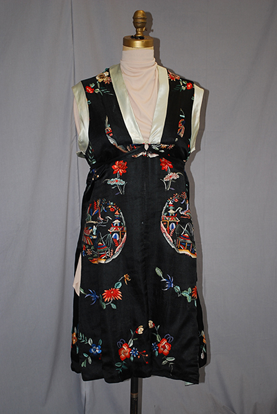 sleeveless black dress with embroidered patterns