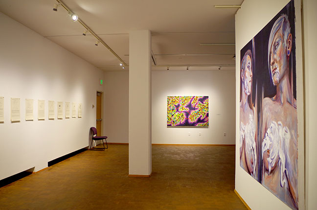 Looking into a gallery space. Paintings are visible.