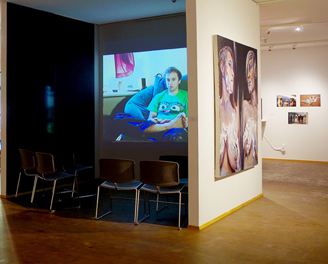 Video installation at left, paintings at right.