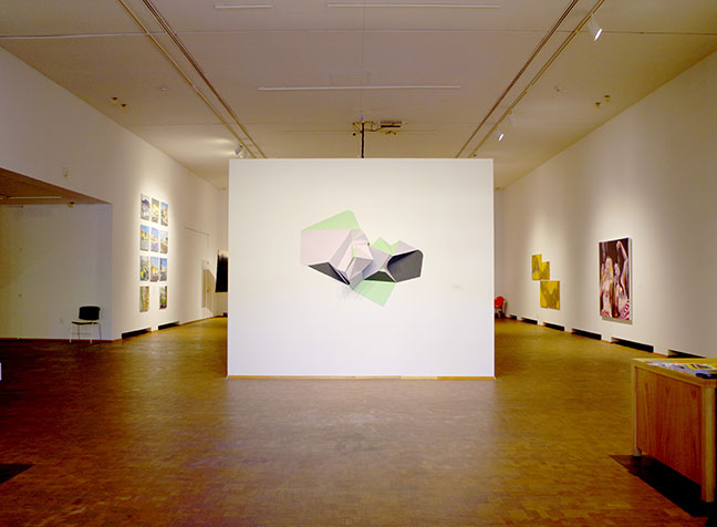 Wide angle view of a gallery with art in it.