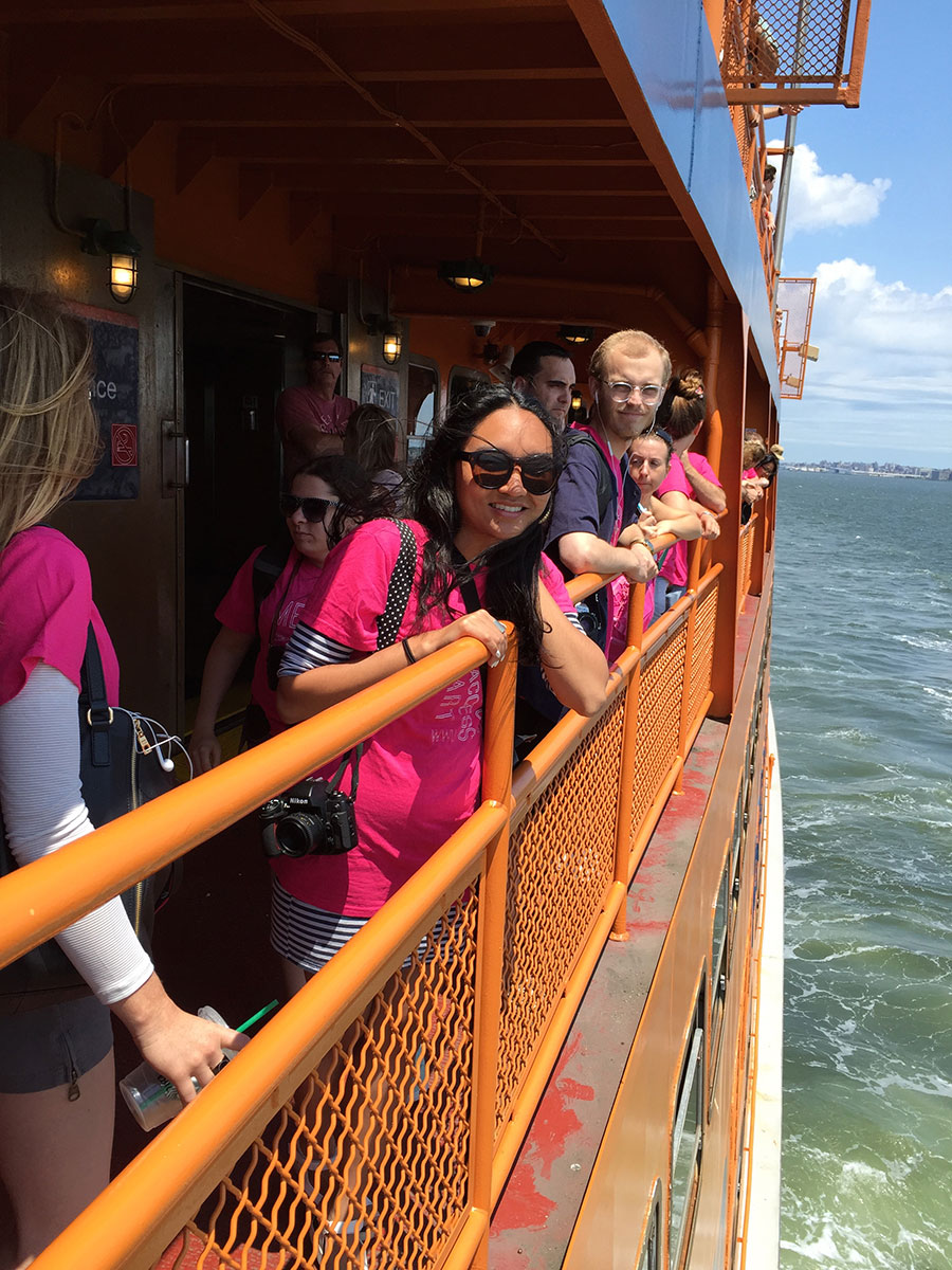 students looking over the rail of the Staten Island Ferry