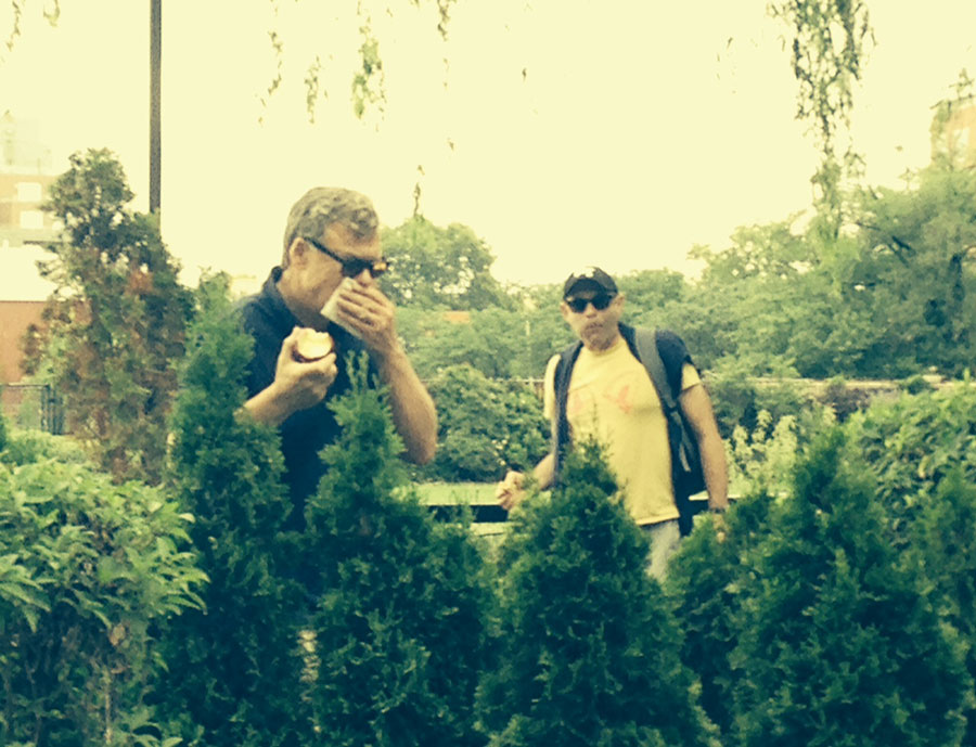 Garth Amundson blowing his nose in a garden