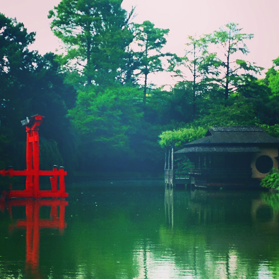 color-saturated photo of a Shinto temple near a pond
