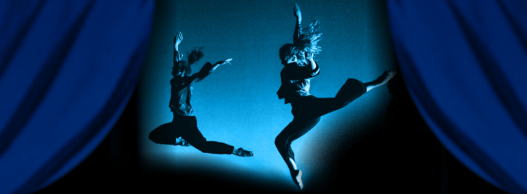 two leaping dancers in profile illuminated in blue light