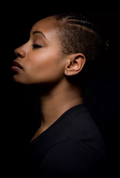 profile of a black woman with eyes closed and chin up