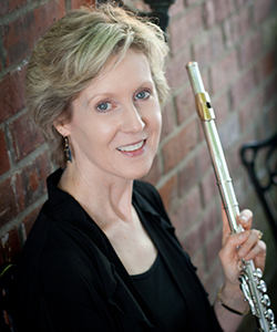 Lisa McCarthy smiles holding a flute