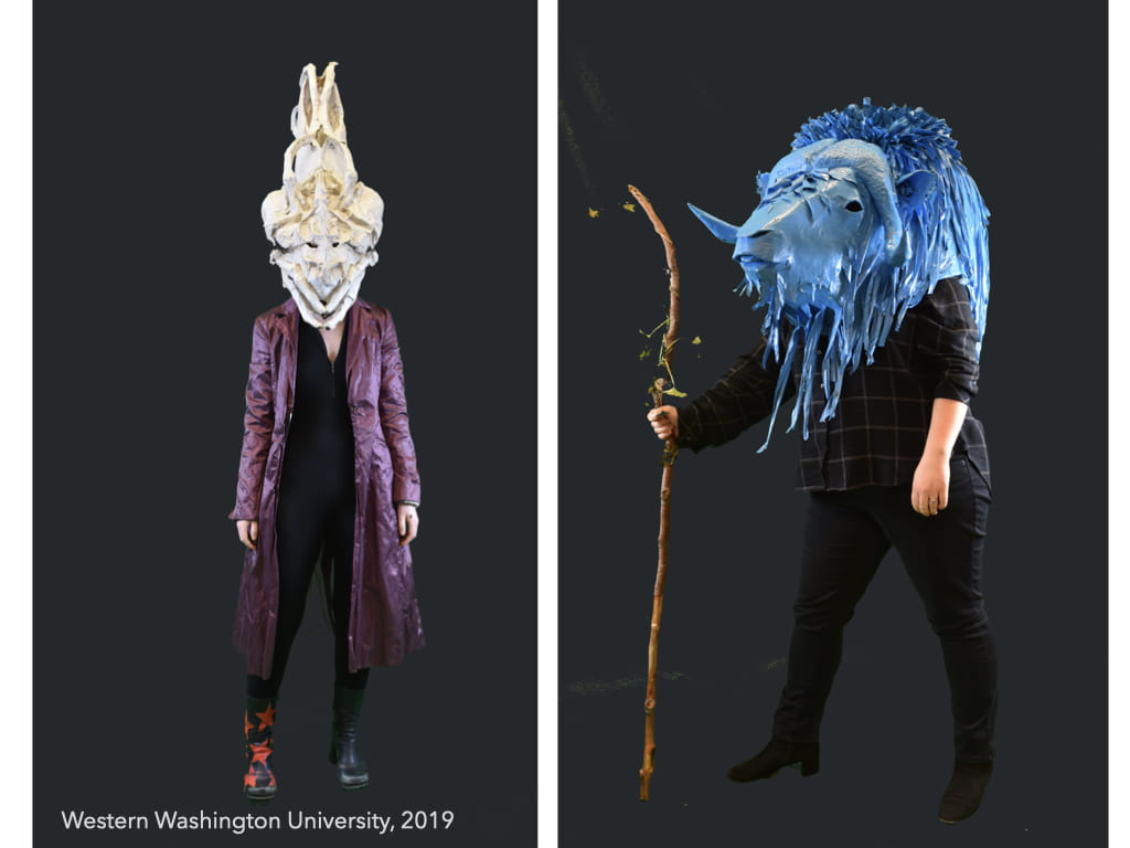 Two images of people posing with full head masks depicting fantastical creature heads. One is tall and narrow, the other looks like a blue, maned buffalo head