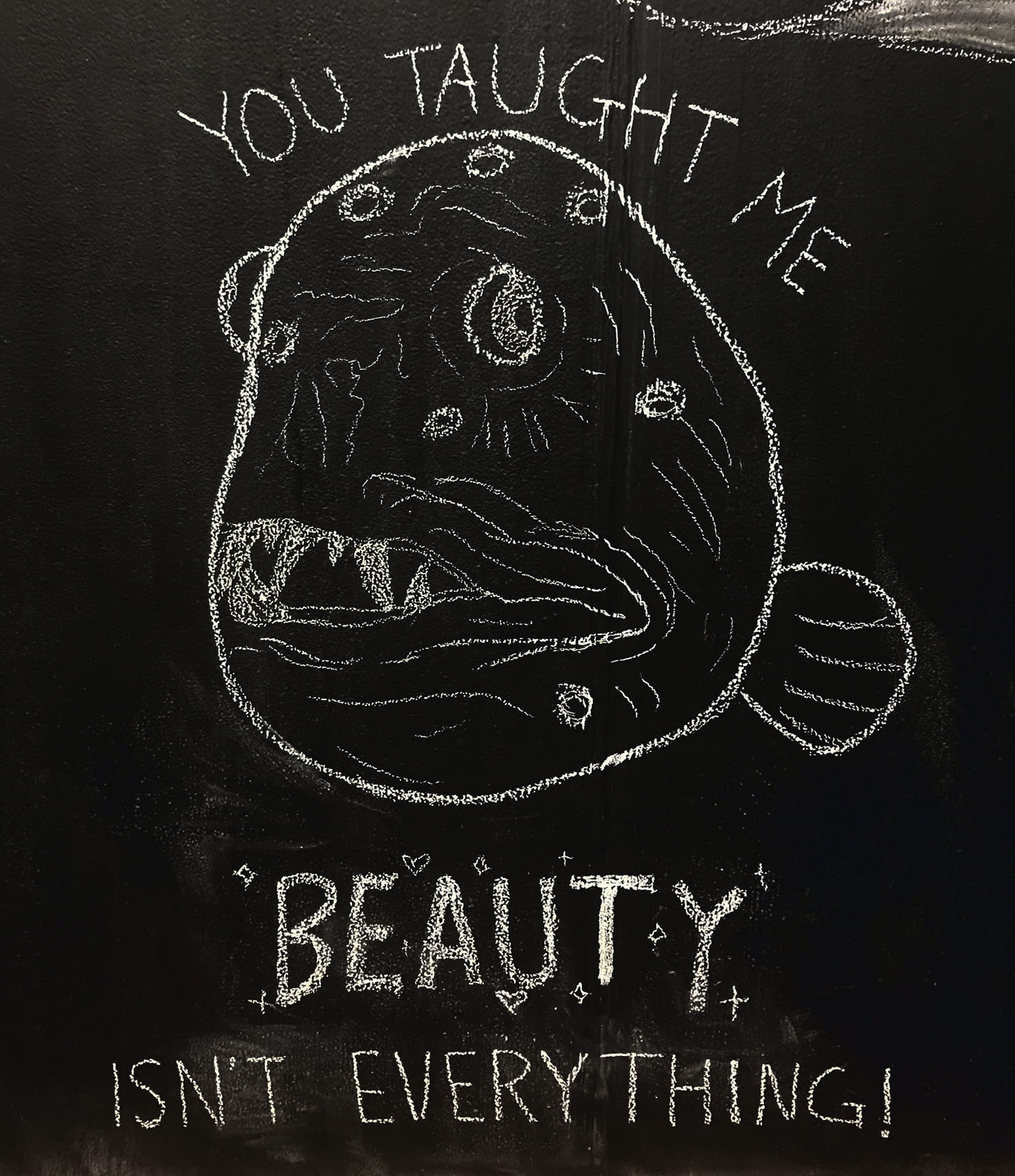 drawing of a round deep-sea fish with spots and large, jagged teeth. Words around it say "You taught me beauty isn't everything!"