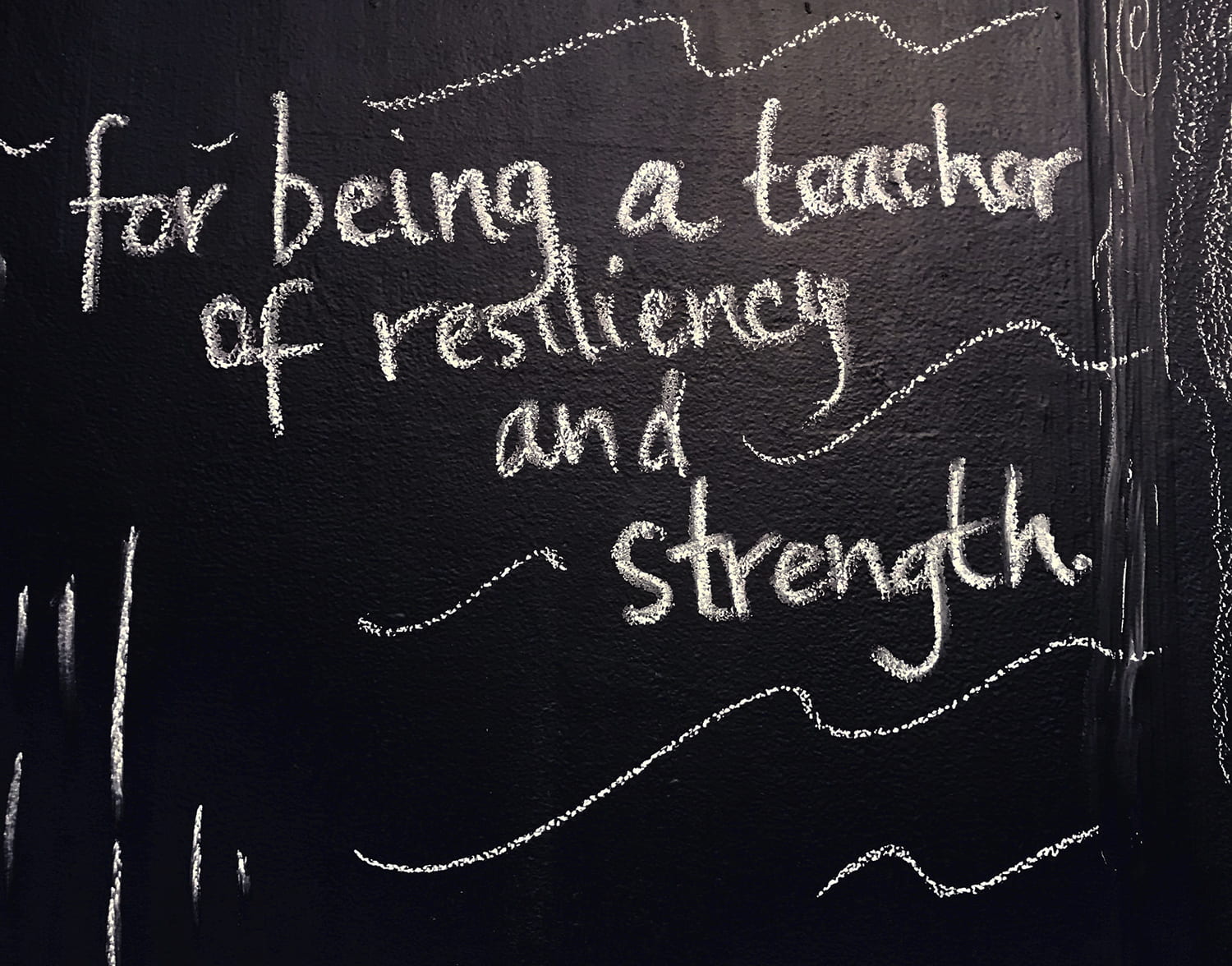handwritten words on a chalkboard: "for being a teacher of resiliency and strength."