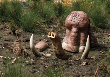Student sculpture of a mammoth emerging from the ground