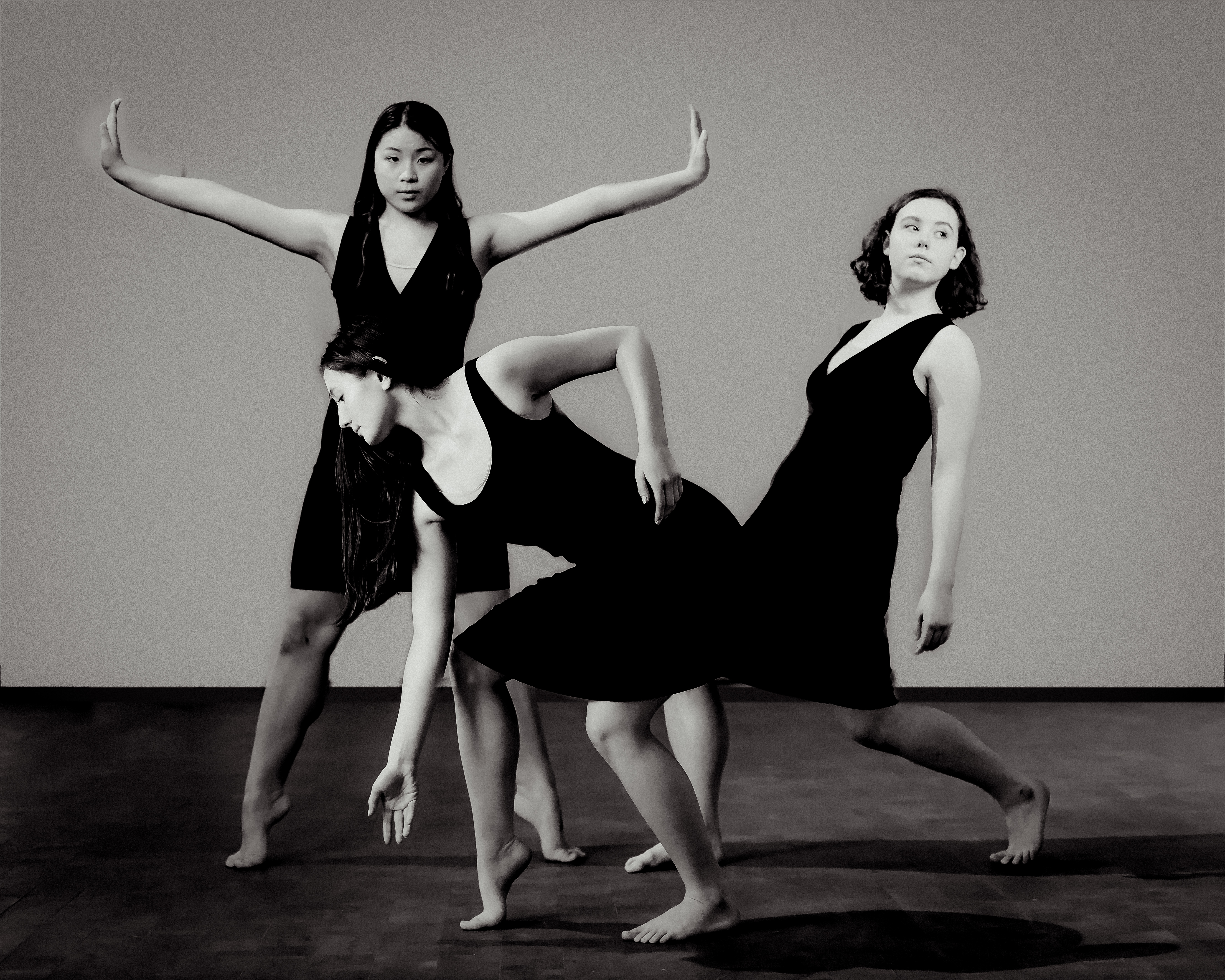 3 dancers close together in dramatic poses