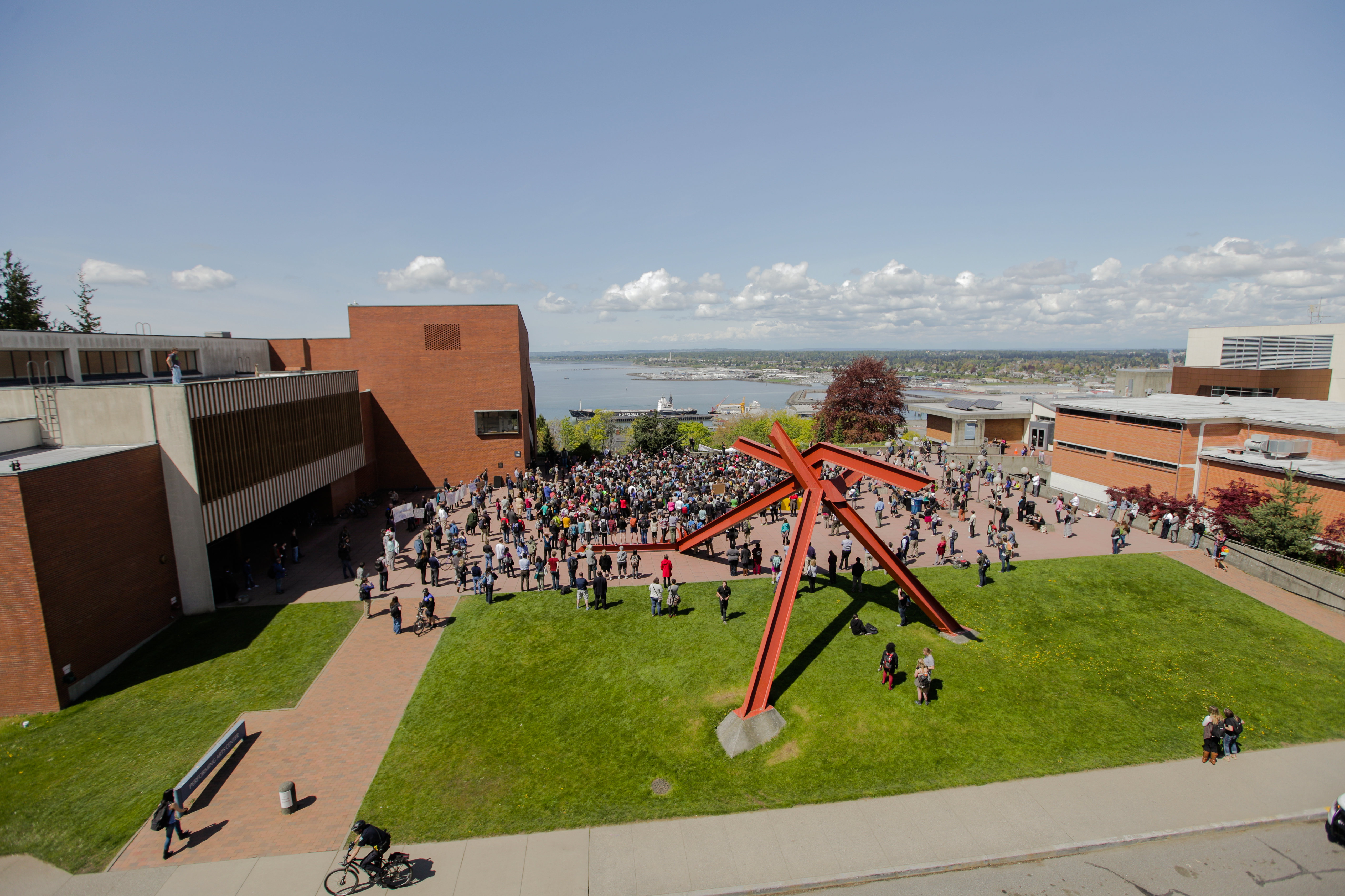 A crowd gathered on the WWU PAC plaza, overlooking the bay on a sunny day