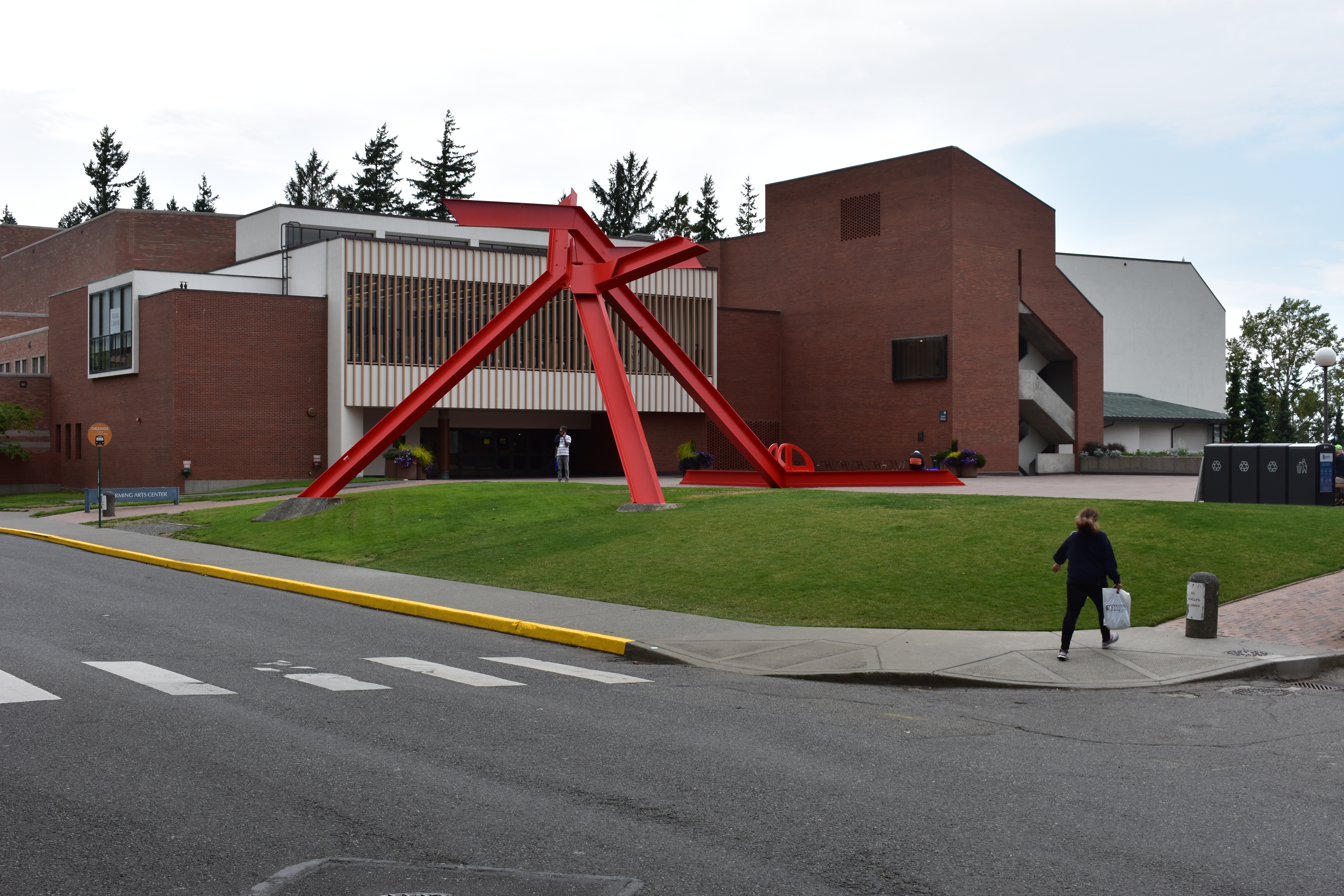 Large triangular sculpture on the lawn in front of the Performing Arts Center plaza and main entrance