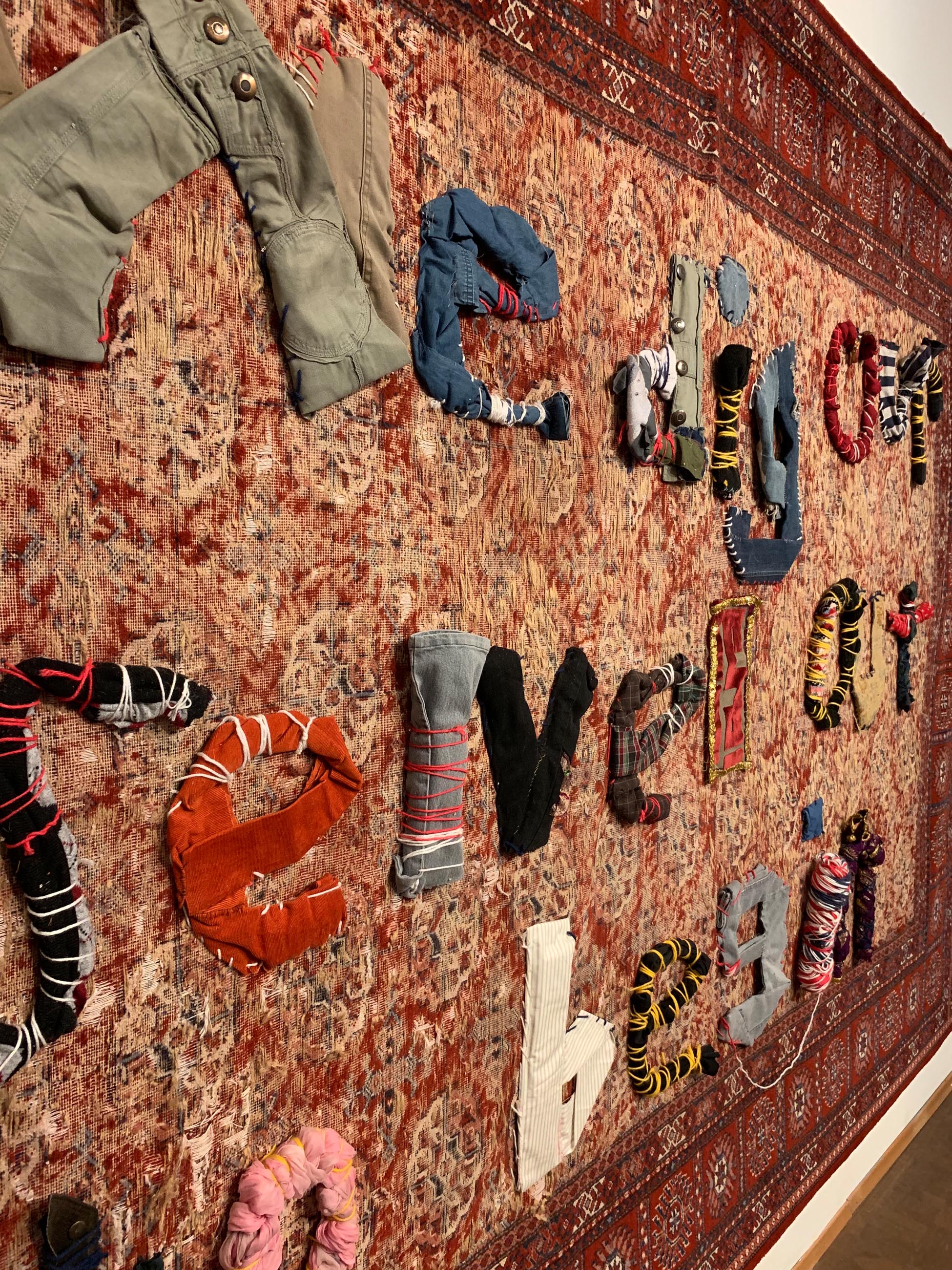letters made of textiles attached to a wall