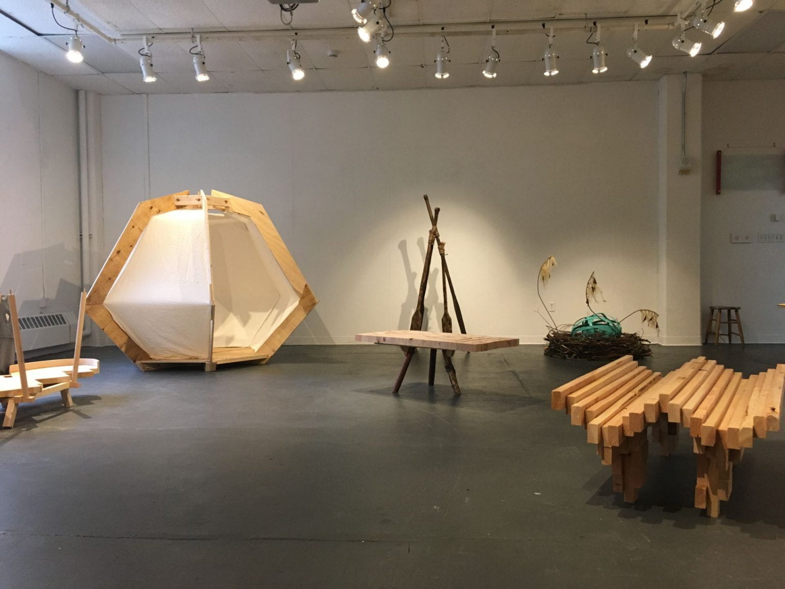 a room with wooden and fabric structures highlighting ryhthmic geometries