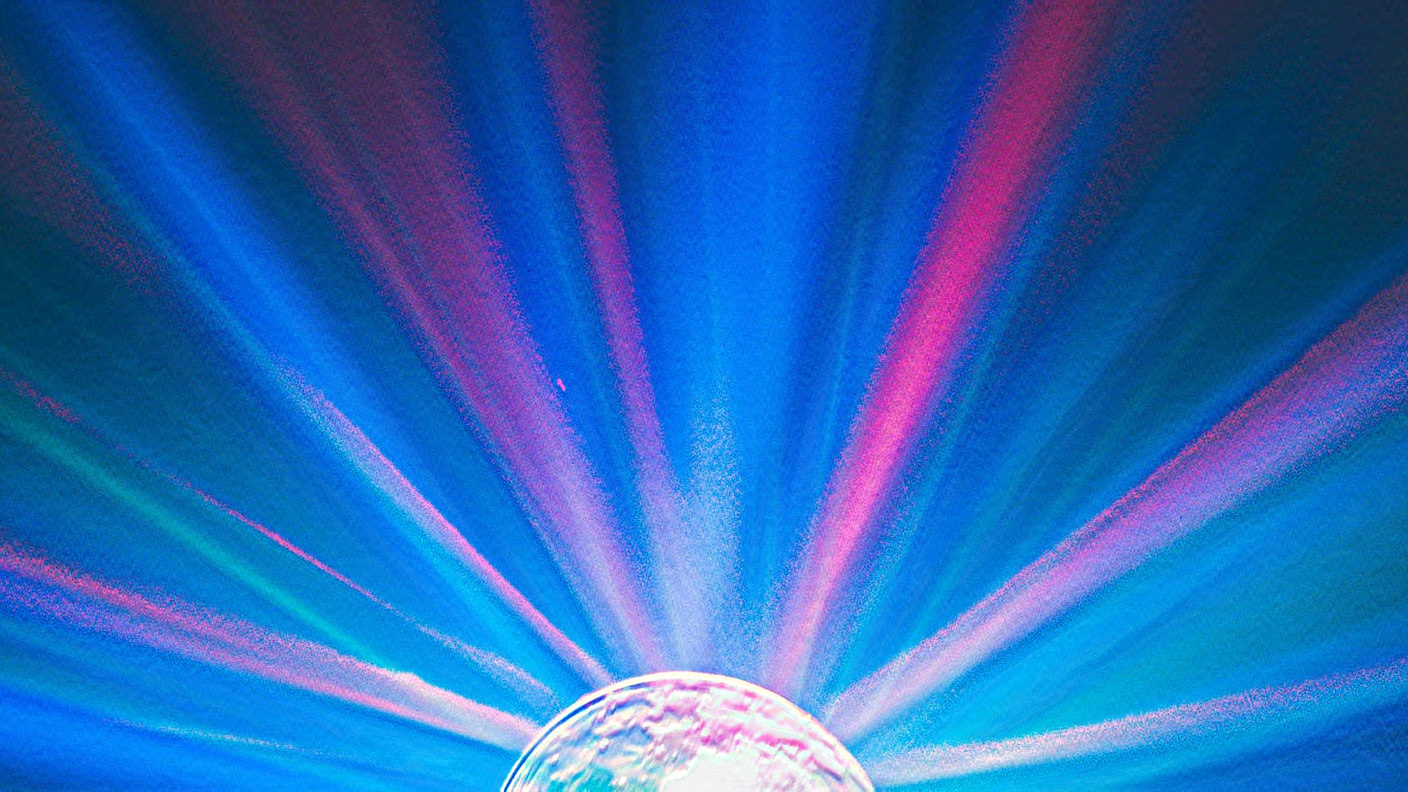 artistic rendering of pink and blue light rays spreading out from a round light source