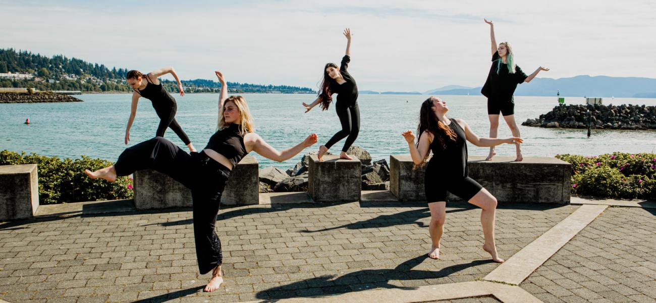 five dancer posing by the bay