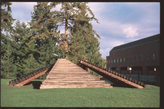 Triangular log ramps propped up to form a pyramid with open corners