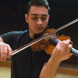 A musician concentrates on playing the violin