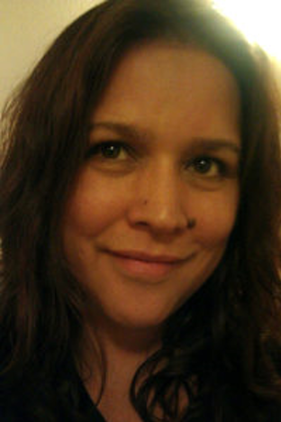 portrait of a smiling person with brown hair