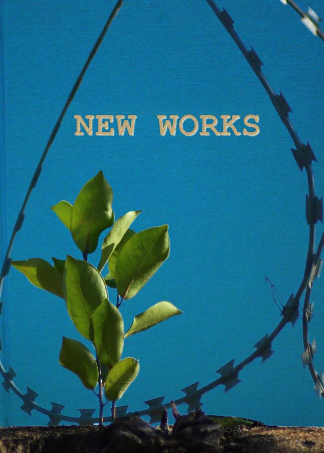 a sapling growing through barbwire in front of a book titled "New Works"
