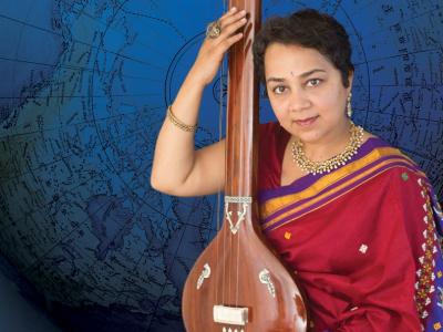 Srivani Jade in traditional Indian dress holding a tanpura instrument in her lap