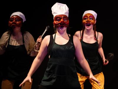 three masked perfomers in chef hats