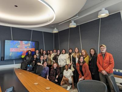 a group of art history students and staff pose in a conference room
