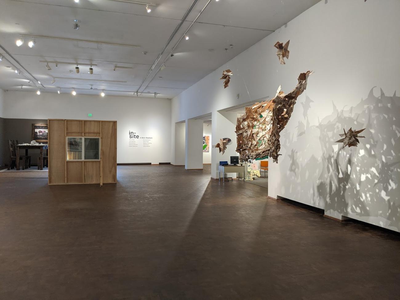 a gallery with several large three dimensional works on display