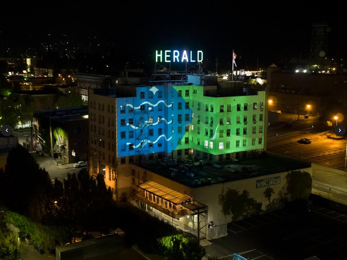 The Bellingham flag projected onto the Herald building at night