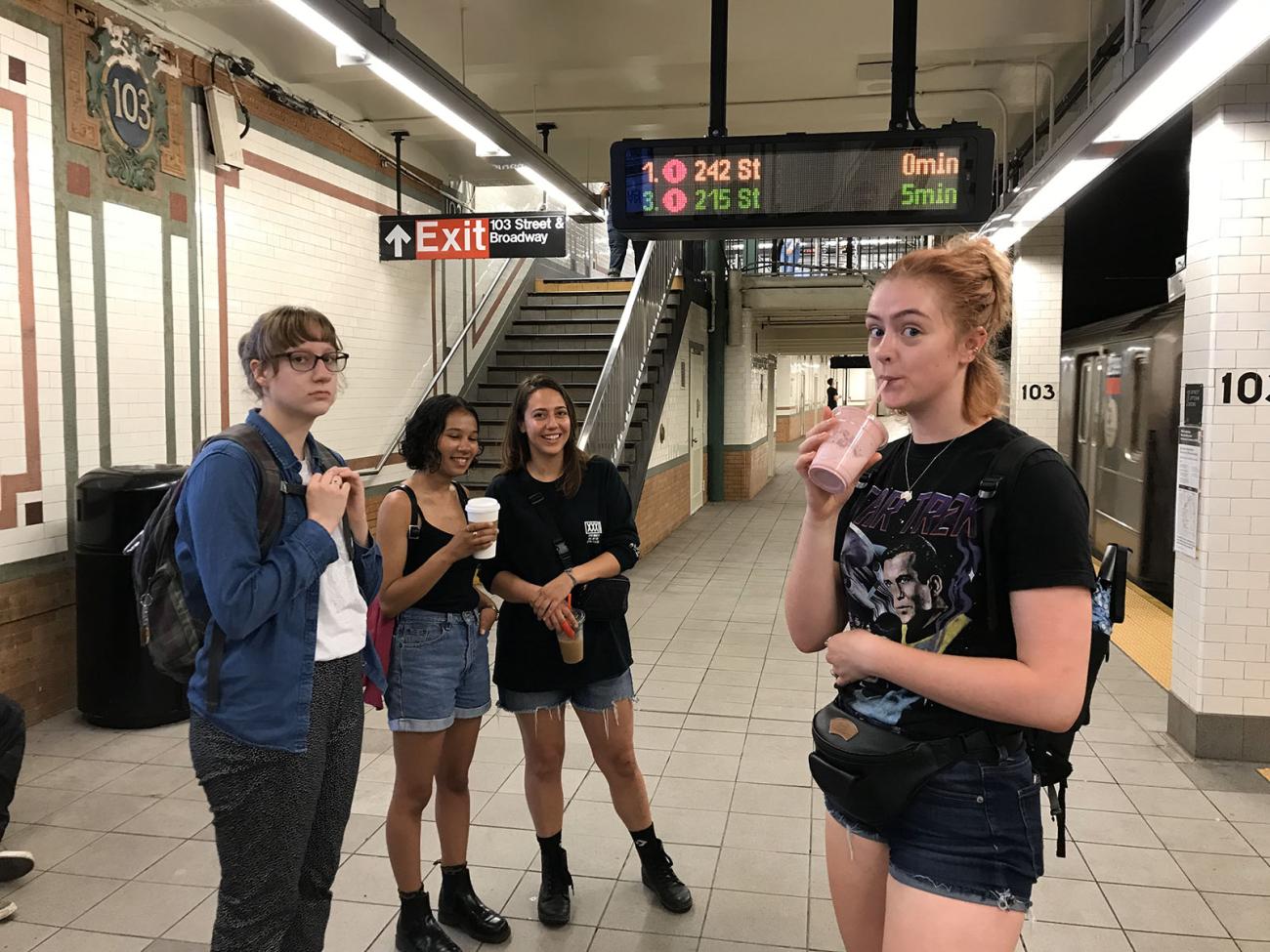 four art students waiting for the subway