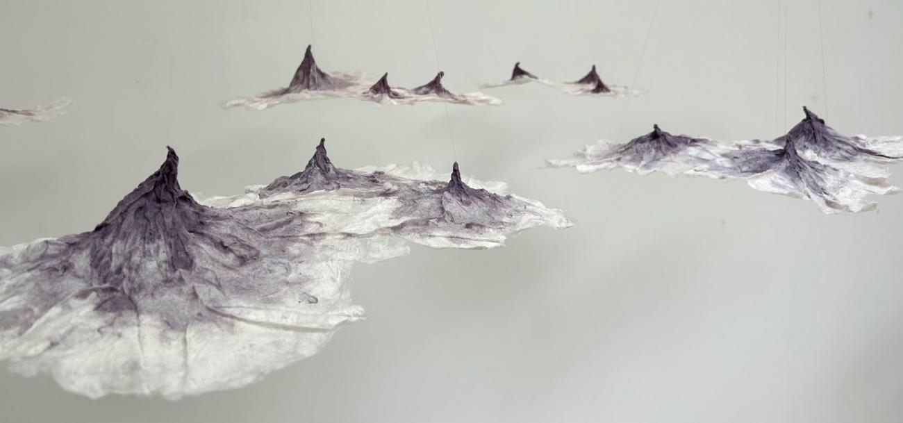 molded textile art installation that looks like curious mountain peaks floating in or above a fog.