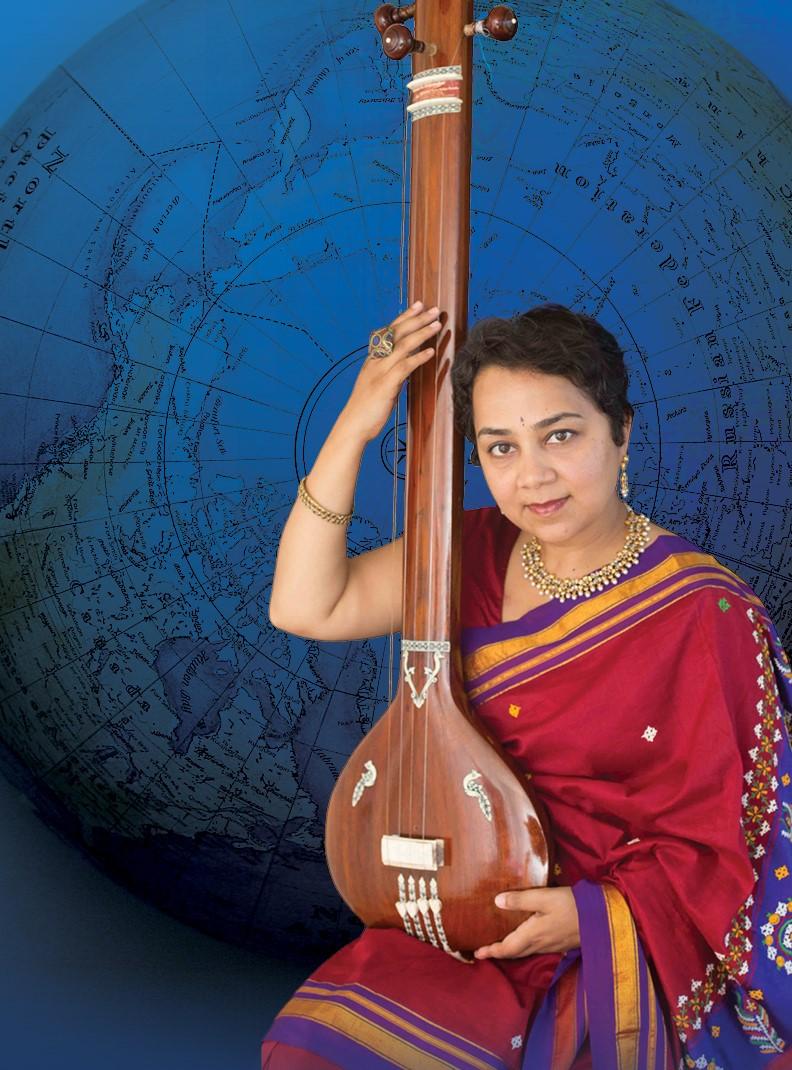 Srivani Jade in traditional Indian dress holding a tanpura instrument in her lap