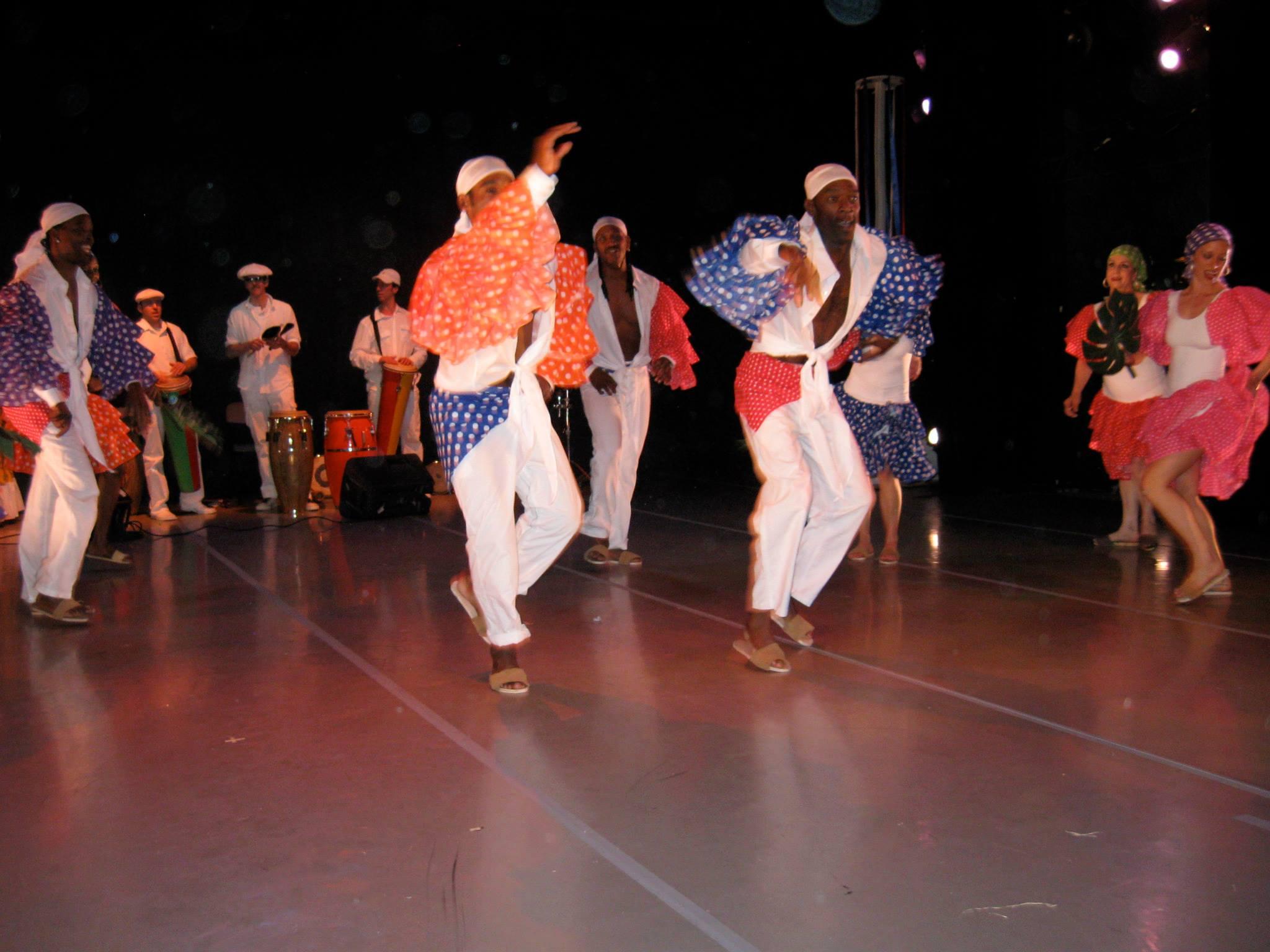 Afrocuban dancers dance with bloused white trousers and colorful sleeves