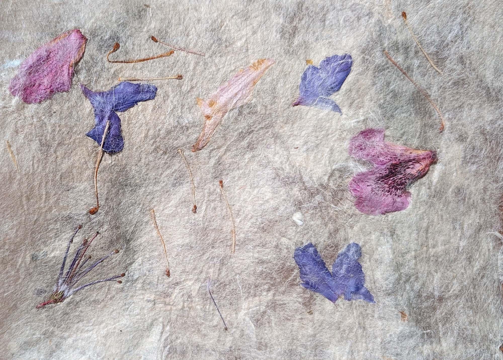 heavily textured hand crafted paper with floral motif in blue and purple