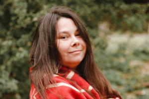 Savannah LeCornu wrapped in a tribal blanket, smiling