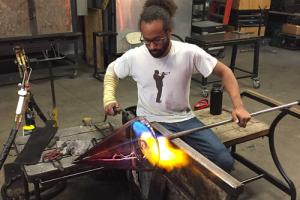 Henry Jackson-Spieker works with molten glass