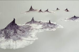 molded textile art installation that looks like curious mountain peaks floating in or above a fog.
