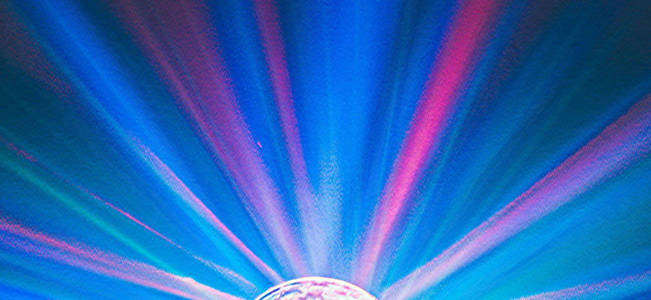 artistic rendering of pink and blue light rays spreading out from a round light source